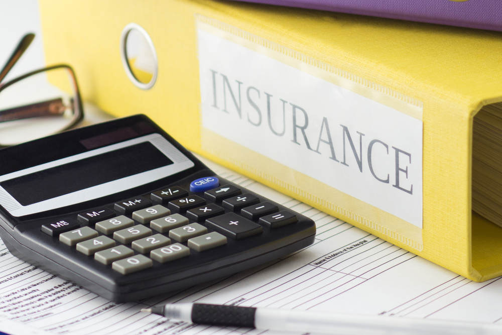 Clean insurance form, folders, glasses, calculator and a pen